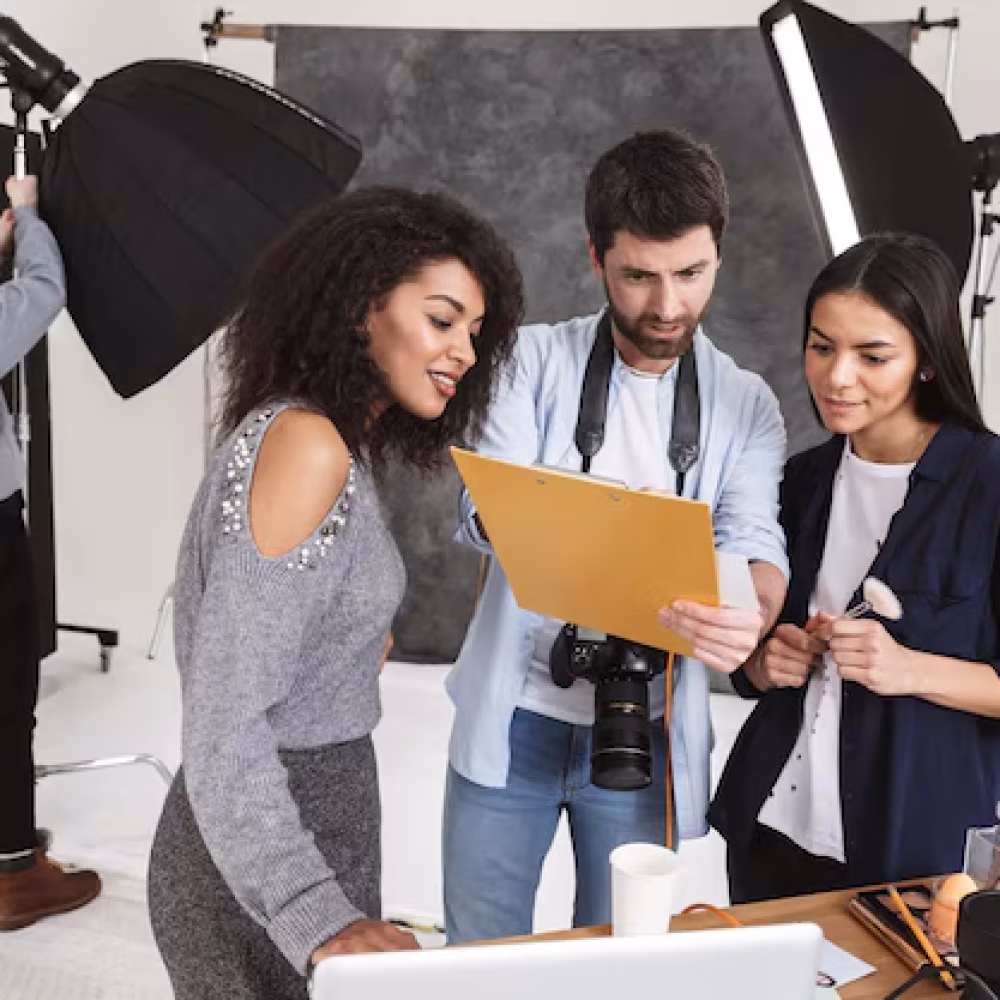 beautiful-african-model-with-makeup-artist-photographer-with-camera-talking-about-their-shooting-backstage-studio-holding-clipboard_171337-93190